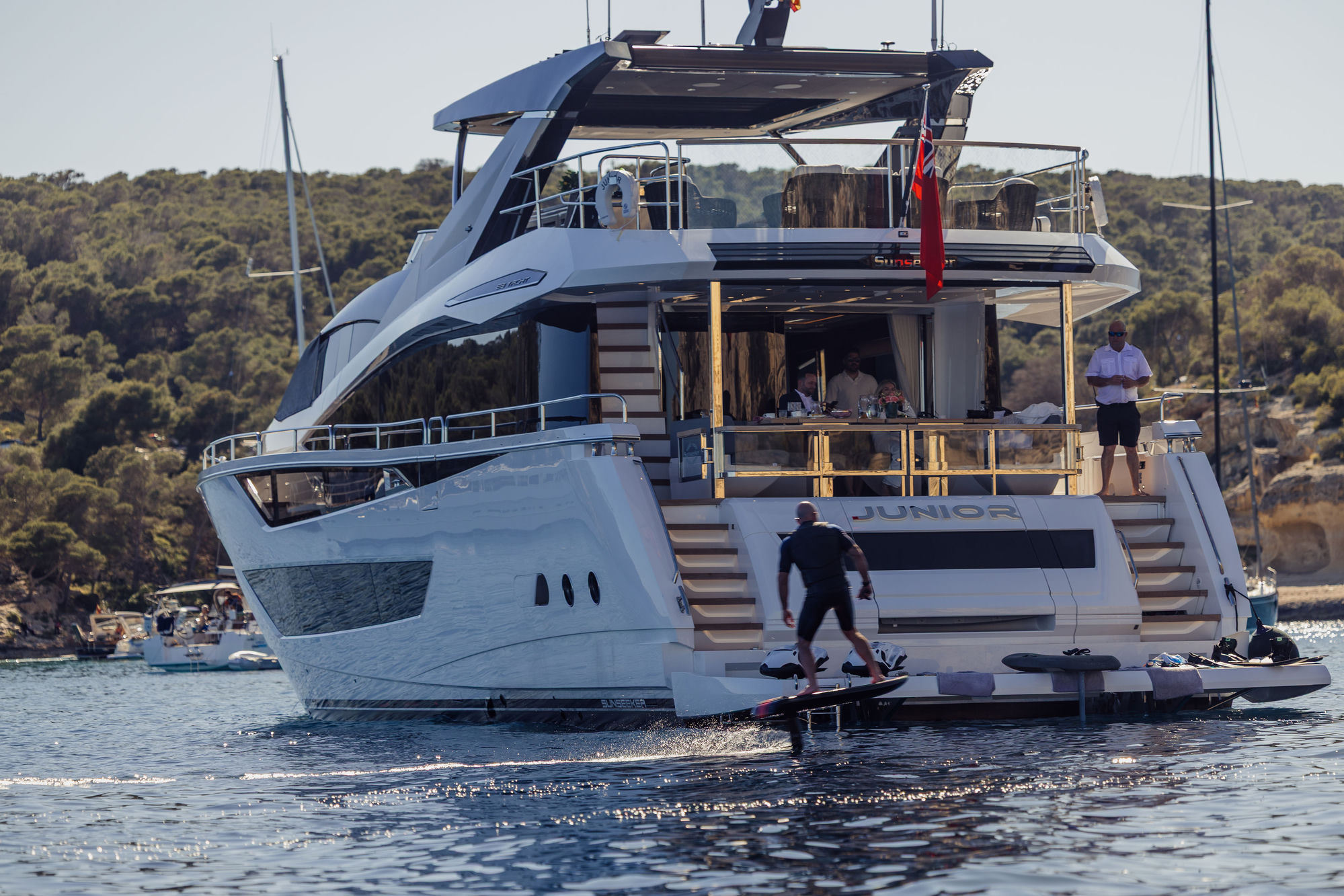 Guest riding electric hydrofoil from M/Y Junior Sunseeker 88 — water toys charter Mallorca