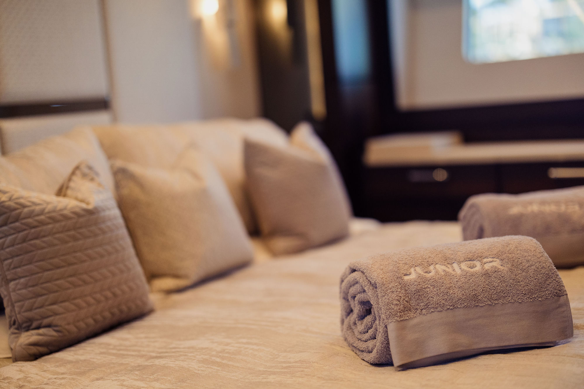 M/Y Junior Sunseeker 88 guest cabin with branded towels — luxury charter details