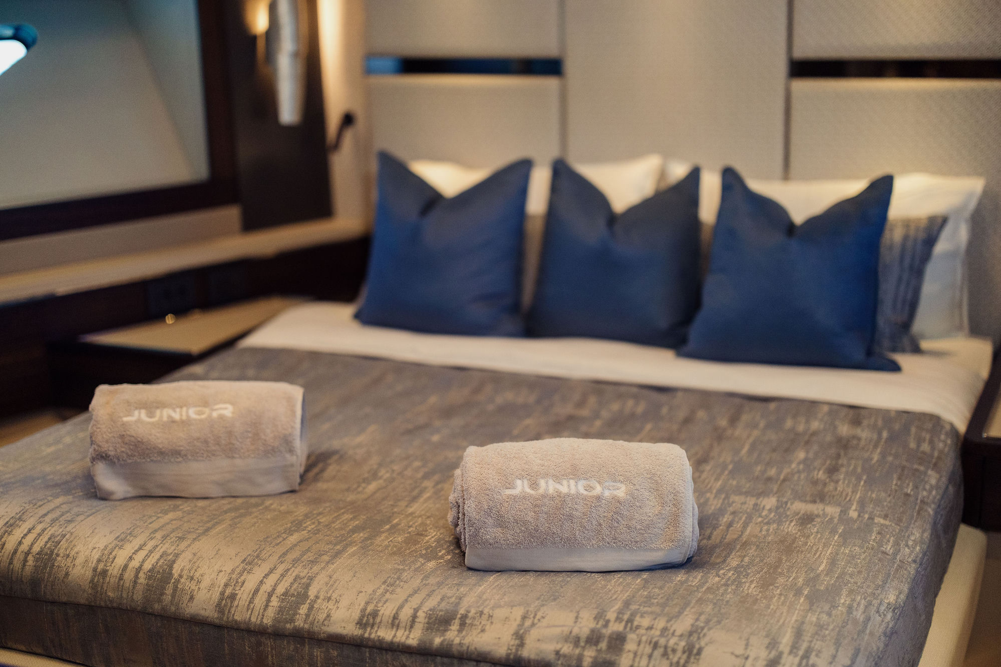 M/Y Junior Sunseeker 88 master cabin with branded towels — luxury charter details