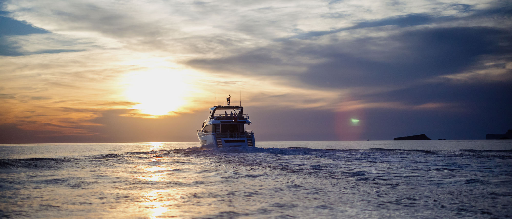 M/Y Junior Sunseeker 88 cruising into sunset — yacht charter Mallorca and Ibiza