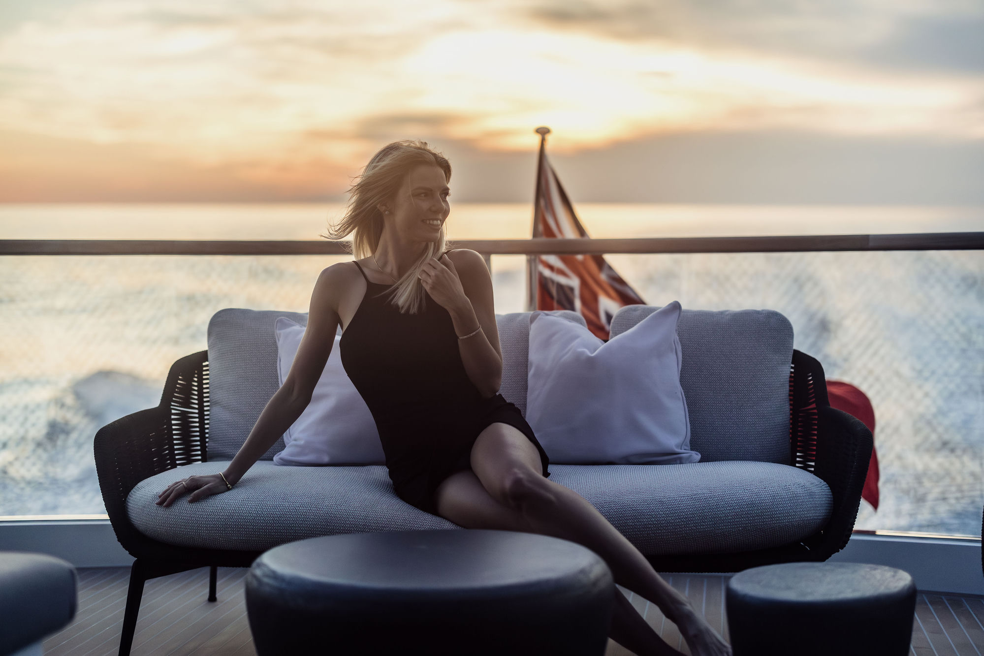 Guest lounging at sunset on aft deck of M/Y Junior Sunseeker 88 — luxury charter Mallorca